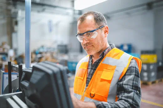 Production worker at machine